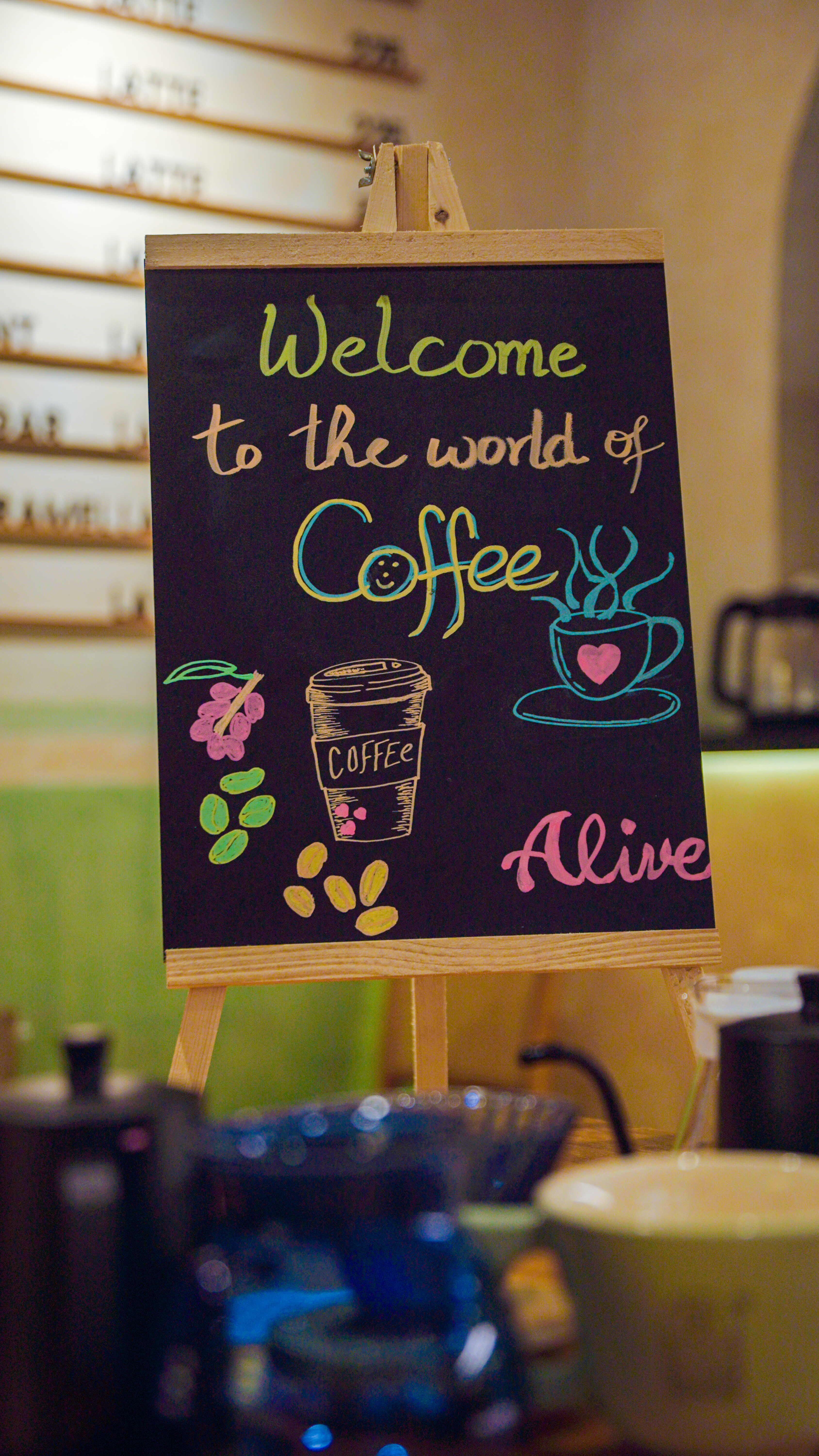 Colorful chalkboard sign welcoming guests to the world of coffee at the brewing event.
